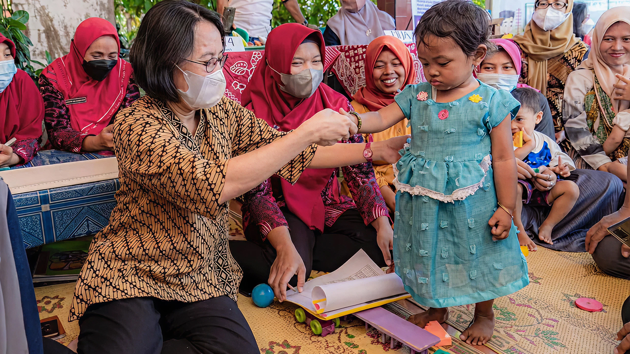 seorang balita yang sedang periksa oleh pegawai kesehatan
